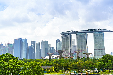 View over the Gardens by the Bay to the three towers of the Marina Bay Sands Hotel and city skyline beyond, Singapore, Southeast Asia, Asia