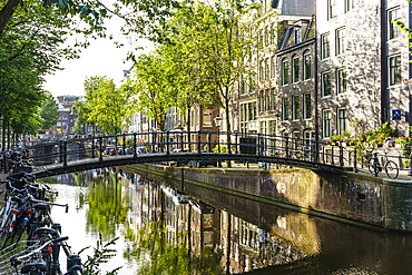 Old gabled buildings reflecting in a canal, Amsterdam, North Holland, The Netherlands, Europe