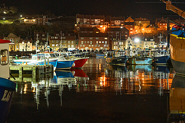 Fishing boats moored in Whitby harbour at night, Whitby, North Yorkshire, England, United Kingdom, Europe