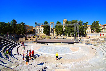 A group of tourists visit the Roman ruins in Arles, a city on the Rhone River, Arles, Bouches-du-Rhone, Provence, France, Europe