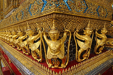 Small Garudas at the base of the Emerald Buddha temple holding a naga (mythical snake creature), Bangkok, Thailand, Southeast Asia, Asia