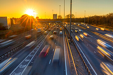 Sunset over M8 motorway traffic, Glasgow, Scotland, United Kingdom, Europe