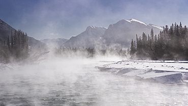 Mist rising off the waters of the Bow River in sub-zero winter weather, Canmore, Alberta, Canadian Rockies, Canada, North America