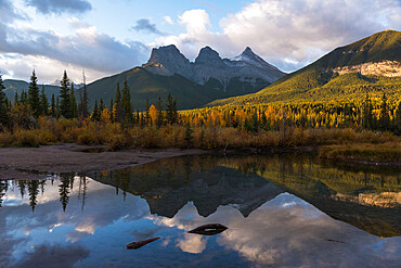 Colourful sunrise over Three Sisters at Policeman Creek in autumn, Canmore, Banff, Alberta, Canadian Rockies, Canada, North America