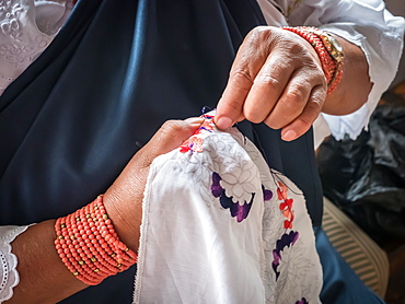 Indigenous woman doing traditional embroidery, Otavalo, Ecuador, South America