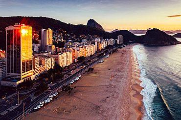 Aerial drone view of Leme Beach in the Copacabana district at sunrise with the iconic Sugarloaf Mountain in the background, UNESCO World Heritage Site, Rio de Janeiro, Brazil, South America