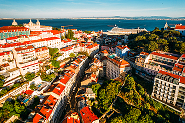 Aerial drone view of Miradouro da Graca with National Pantheon visible on far left, and large cruise ship moored on the Tagus River harbour, Lisbon, Portugal, Europe