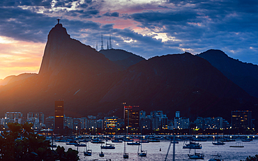 View of Botafogo Bay at sunset with Christ the Redeemer statue in the background, UNESCO World Heritage Site, between the Mountain and the Sea, inscribed on the World Heritage List in 2012, Rio de Janeiro, Brazil, South America