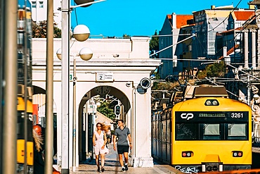 A man and women walk along the platform at Estoril train station in the outskirts of Lisbon, Portugal, Europe