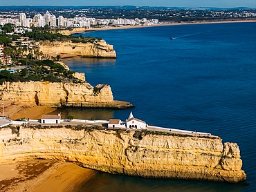 Aerial drone view of the Fort of Nossa Senhora da Rocha (also known as the Fort of Our Lady of the Rock or Castle of Porches), a medieval castle situated in the civil parish of Porches, in the municipality of Lagoa in Portuguese Algarve