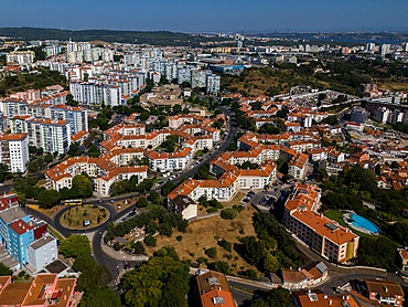 Aerial drone view of geometric Soviet-era apartment blocks in Carnaxide district in Lisbon, Portugal