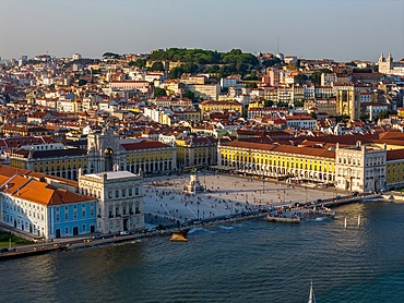 Aerial drone view of Praca do Comercio in Lisbon, Portugal with major landmarks visible such as Castelo Sao Jorge and Se Cathedral