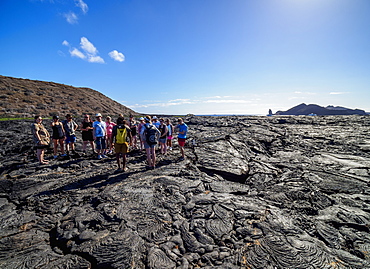 Tourists visiting Lava field in Sullivan Bay, Santiago (James) Island, Galapagos, UNESCO World Heritage Site, Ecuador, South America