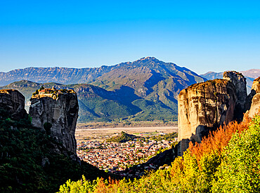 View towards the Monastery of the Holy Trinity and Kalabaka at sunrise, Meteora, UNESCO World Heritage Site, Thessaly, Greece, Europe