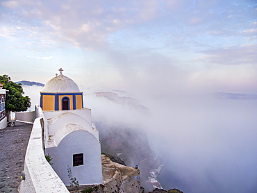 Church of Saint Stylianos at foggy sunrise, Fira, Santorini (Thira) Island, Cyclades, Greek Islands, Greece, Europe