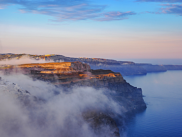 Caldera and Fira City at foggy sunrise, Santorini (Thira) Island, Cyclades, Greek Islands, Greece, Europe