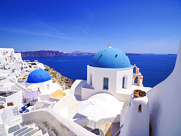 Iconic blue domed churches of Resurrection of the Lord and Saint Spyridon, Oia Village, Santorini (Thira) Island, Cyclades, Greek Islands, Greece, Europe