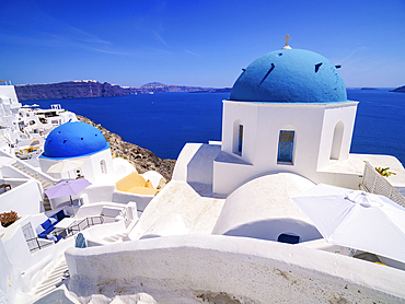 Iconic blue domed churches of Resurrection of the Lord and Saint Spyridon, Oia Village, Santorini (Thira) Island, Cyclades, Greek Islands, Greece, Europe