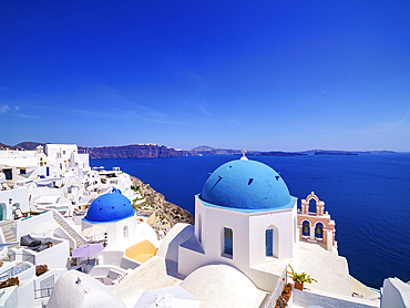 Iconic blue domed churches of Resurrection of the Lord and Saint Spyridon, Oia Village, Santorini (Thira) Island, Cyclades, Greek Islands, Greece, Europe