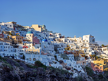 View towards the blue domed churches of Resurrection of the Lord and Saint Spyridon at sunset, Oia Village, Santorini (Thira) Island, Cyclades, Greek Islands, Greece, Europe