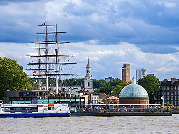 View over River Thames towards Cutty Sark British Clipper Ship and St. Alfege Church in Greenwich, London, England, United Kingdom, Europe