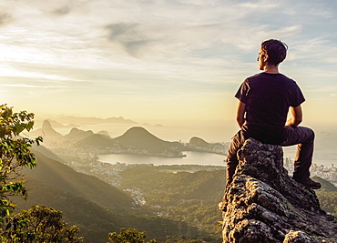 Hiker enjoying the view of Rio de Janeiro from Pedra da Proa, Tijuca Forest National Park, State of Rio de Janeiro, Brazil, South America