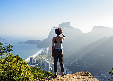 Brazilian girl looking towards the Pedra da Gavea and Sao Conrado from Dois Irmaos Mountain, Rio de Janeiro, Brazil, South America