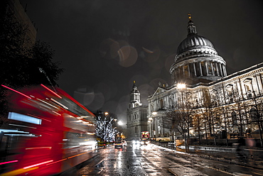 A London bus drives past St. Paul's Cathedral towards Christmas lights, London, England, United Kingdom, Europe