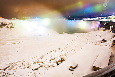 Frozen Niagara Falls in March illuminated at night, Niagara, Ontario, Canada, North America