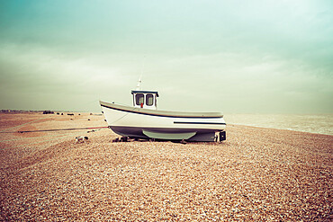 Fishing boats on the shingle beach waiting to go back out to the water, Dungeness, Kent, England, United Kingdom, Europe