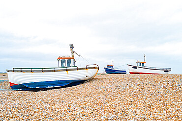 Fishing boats on the shingle beach waiting to go back out to the water, Dungeness, Kent, England, United Kingdom, Europe