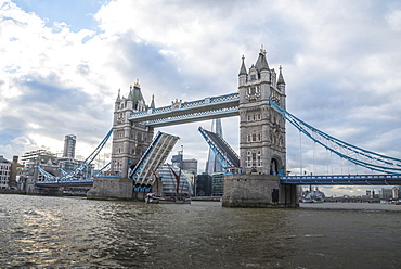 Tower Bridge raised with tall ship passing through with London's City Hall and the Shard in the background, London, England, United Kingdom, Europe