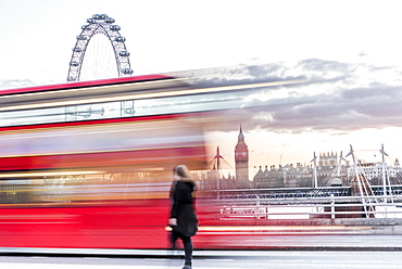 A lady crossing Waterloo Bridge with a bus passing between her, the London Eye and Big Ben, London, England, United Kingdom, Europe