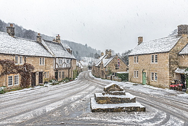 Looking down the quintessential English village of Castle Combe in the snow, Wiltshire, England, United Kingdom, Europe