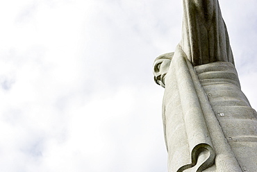 Low angle cropped shot of the iconic statue of Christ the Redeemer on a cloudy day, Rio de Janeiro, Brazil, South America