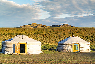 Two Mongolian nomadic gers and mountains in the background, Bayandalai district, South Gobi province, Mongolia, Central Asia, Asia