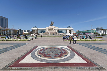 Tourists in Sukhbaatar square with Damdin Sukhbaatar statue, Ulan Bator, Mongolia, Central Asia, Asia