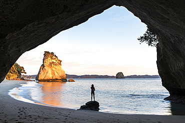 Woman's silhouette at Cathedral Cove, Hahei, Waikato region, North Island, New Zealand, Pacific