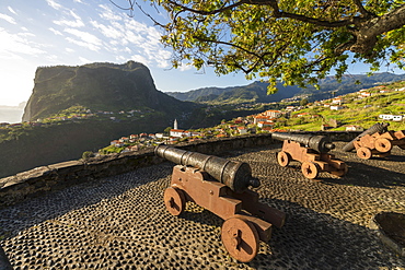 Historical cannons at Faial fortress with the village in the background, Faial, Santana municipality, Madeira, Portugal, Atlantic, Europe