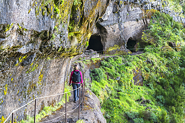 Woman walking on the trail from Pico Ruivo to Pico do Areeiro, Santana municipality, Madeira, Portugal, Europe