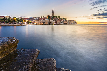 The old town at sunset, in summer, with stone steps in the foreground, Rovinj, Istria county, Croatia, Europe