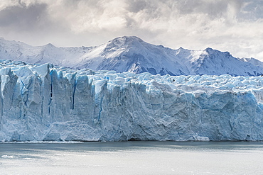 Perito Moreno glacier and mountain peak under a moody sky, Los Glaciares National Park, UNESCO World Heritage Site, Santa Cruz, Argentina, South America