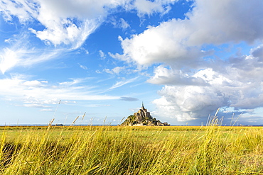 Clouds in the sky and grass in the foreground, Mont-Saint-Michel, UNESCO World Heritage Site, Normandy, France, Europe