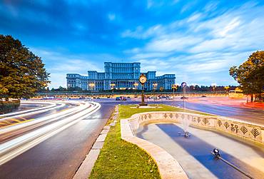 Car light trails at blue hour in front of the huge Palace of Parliament (Palatul Parlamentului), Bucharest, Romania, Europe