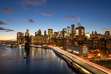 The lights of Lower Manhattan at dusk viewed from the Manhattan Bridge, New York, United States of America, North America