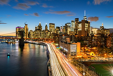 The lights of Lower Manhattan at dusk viewed from the Manhattan Bridge, New York, United States of America, North America