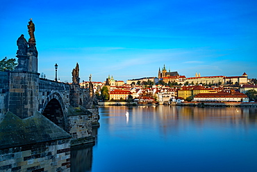 The early morning sun lights up St. Vitus Cathedral and Prague Castle, UNESCO World Heritage Site, Prague, Czech Republic, Europe