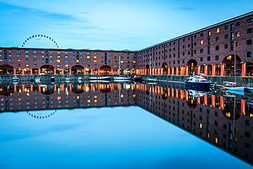 The Wheel of Liverpool seen behind the Albert Dock on the River Mersey waterfront, during the evening twilight (blue hour), Liverpool, Merseyside, England, United Kingdom, Europe