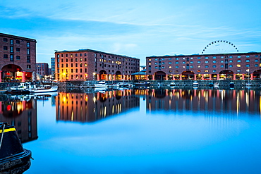 The Wheel of Liverpool seen behind the Albert Dock on the River Mersey waterfront, during the evening twilight (blue hour), Liverpool, Merseyside, England, United Kingdom, Europe