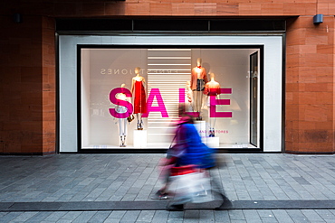 The movement of shoppers at Liverpool One shopping centre in front of a shop with a sale on, Liverpool, Merseyside, England, United Kingdom, Europe